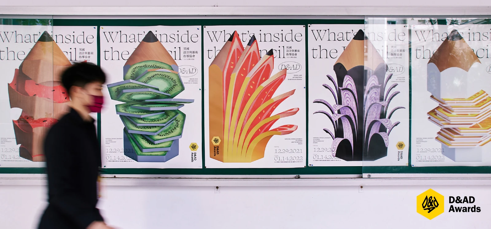 The D&AD fruit-pencil posters with a visitor walking past