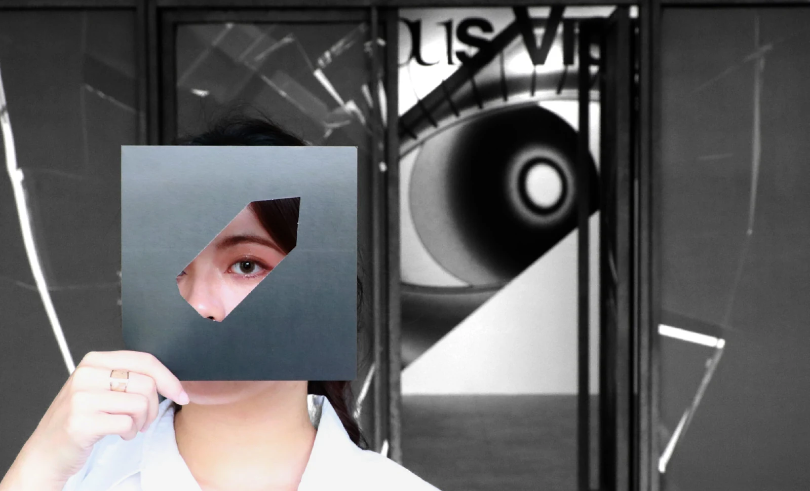 A visitor holding an eye graphic within the exhibition