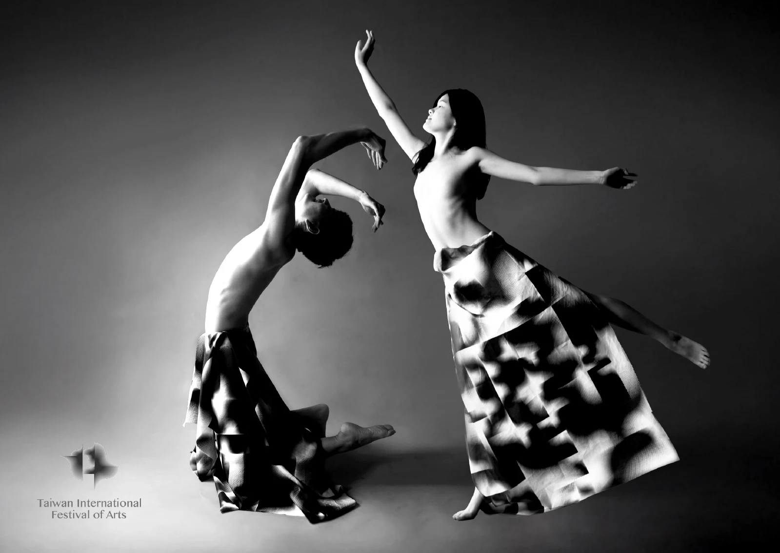Dancers wearing black-and-white patterned fabric