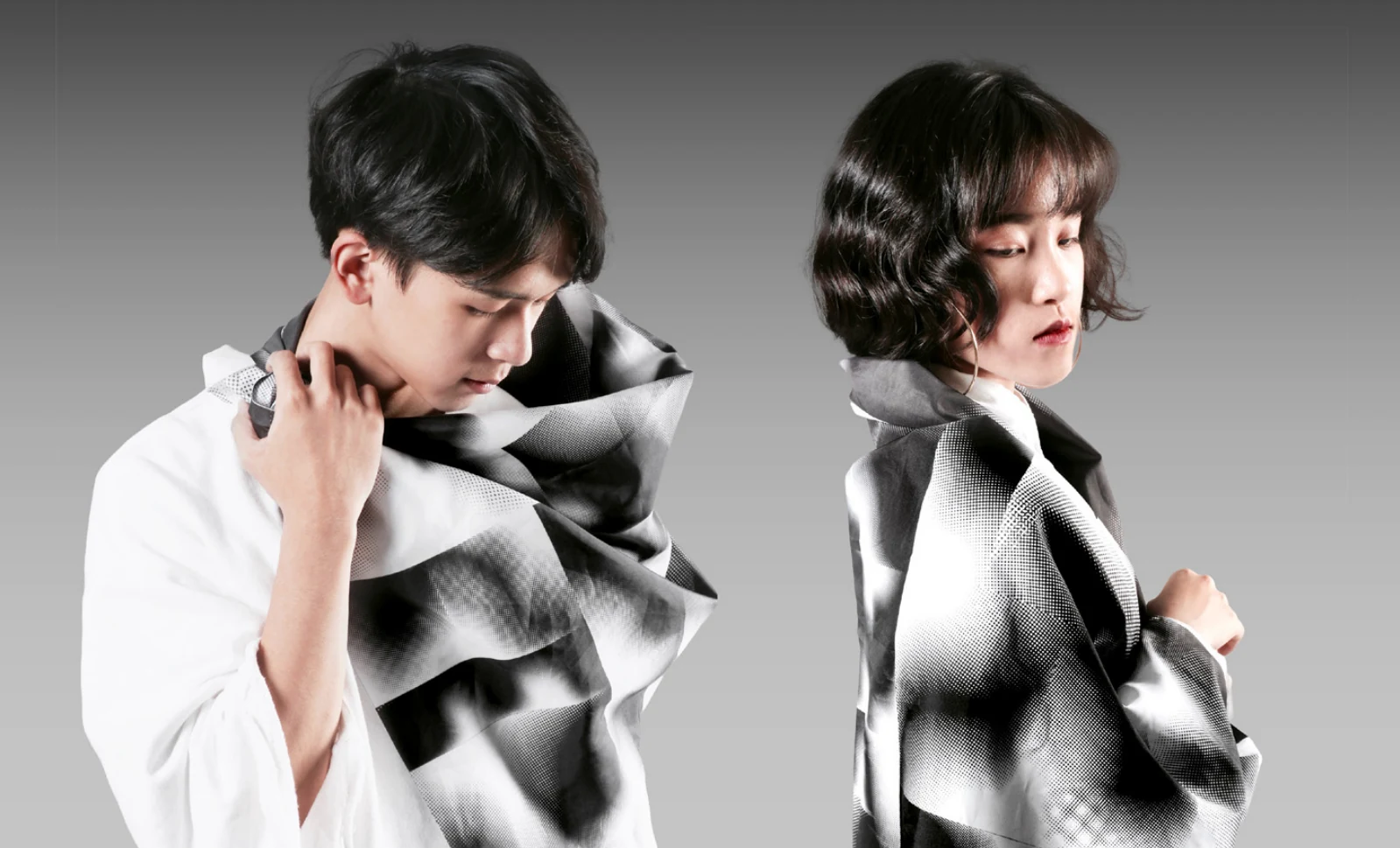 Two models wrapped in the festival’s printed fabric