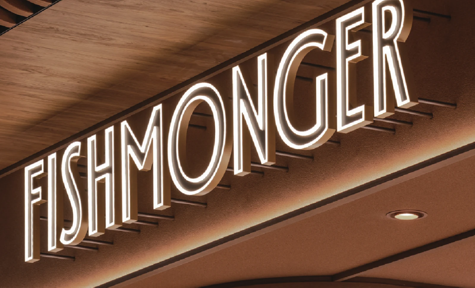 The illuminated Fishmonger storefront sign