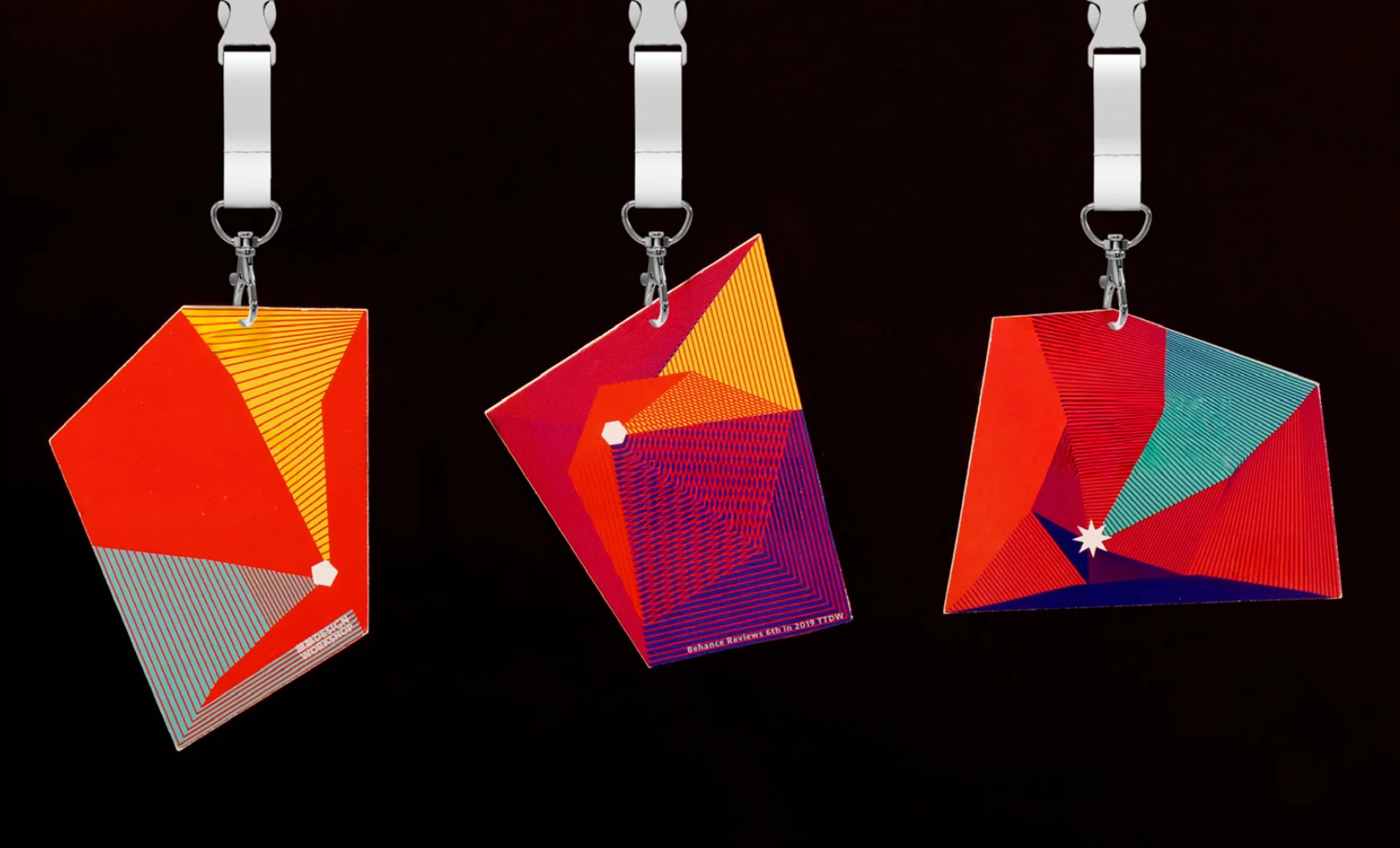 Three hanging badges with faceted door-shaped designs