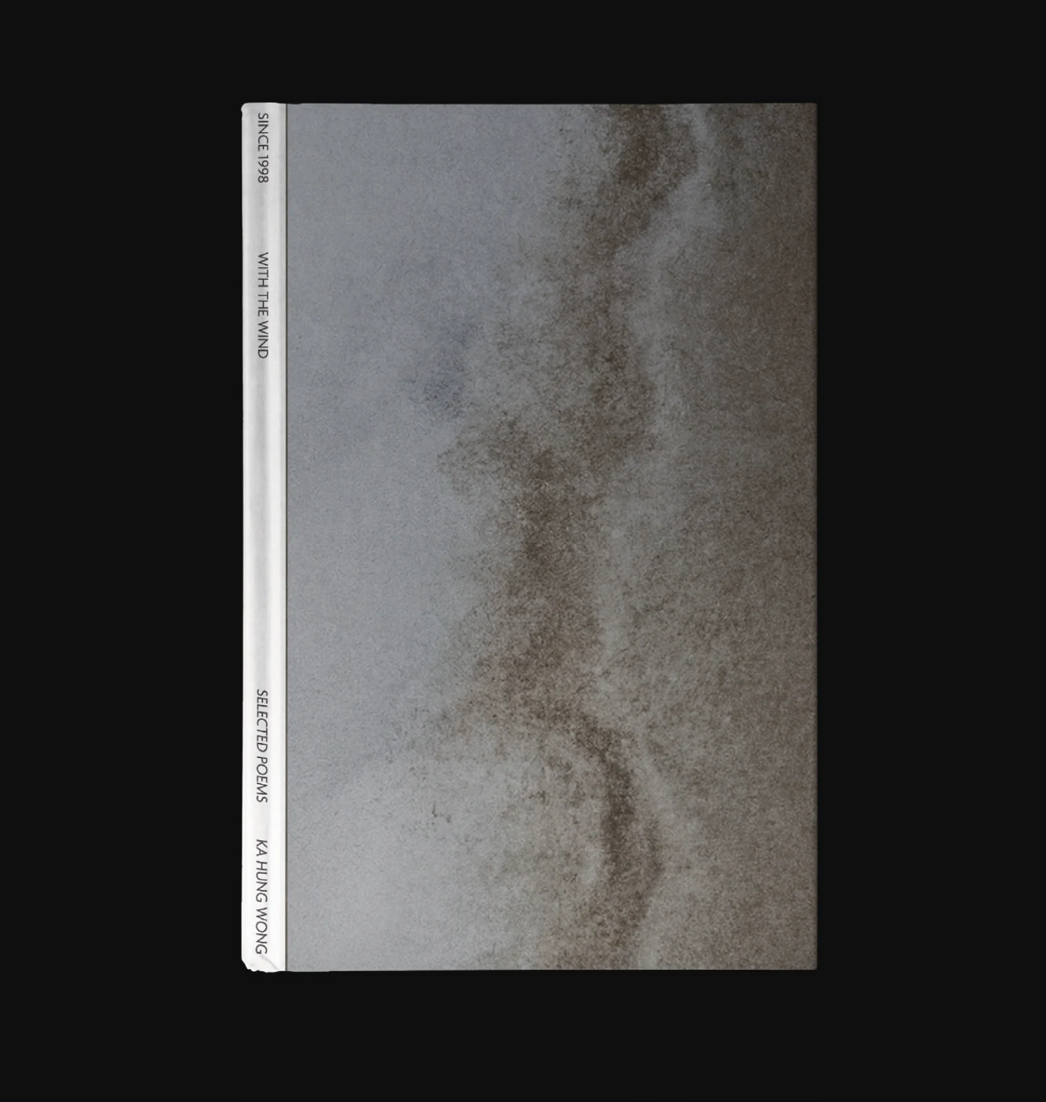 The front cover with drifting sand patterns and a white spine, on black